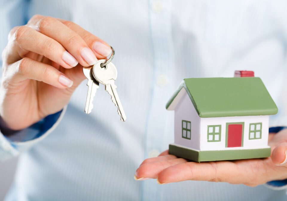 Businessman Holding House Model and Keys, Real Estate Concept